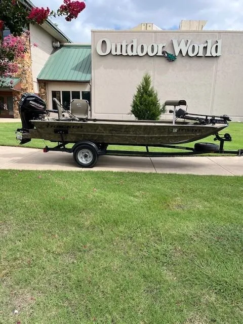 Slide: The Image of 2023 Tracker 1654SPT boat on trailer outside Outdoor World store. - 6