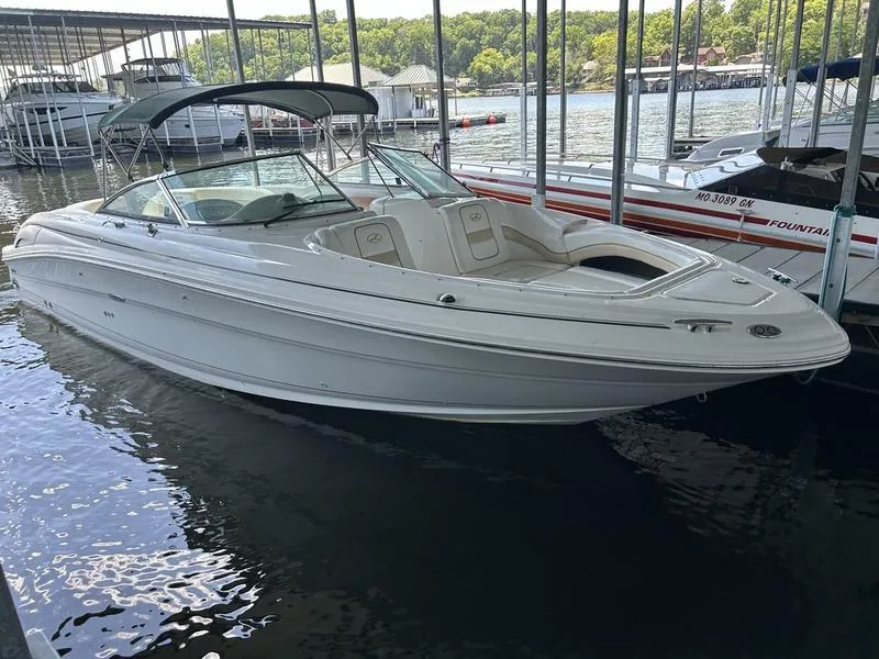 Slide: The Image of 2002 Sea Ray 290 boat docked in a marina, featuring sleek white design. - 13
