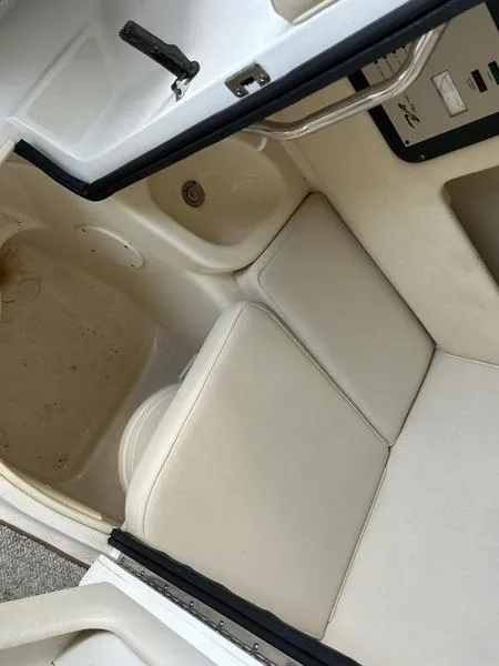 Slide: The Image of 2002 Sea Ray 290 boat interior with white seating and sink. - 7