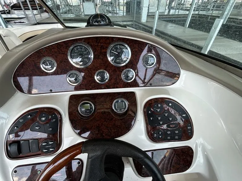 Slide: The Image of Dashboard of a 2002 Sea Ray 290 boat with gauges and controls. - 8