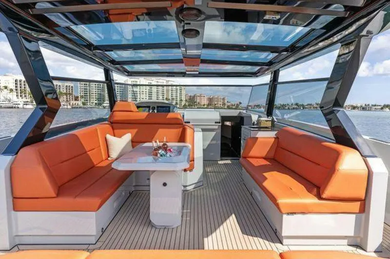 Slide: The Image of Luxurious 2021 Vanquish VQ58 yacht interior with orange seating and panoramic views. - 13
