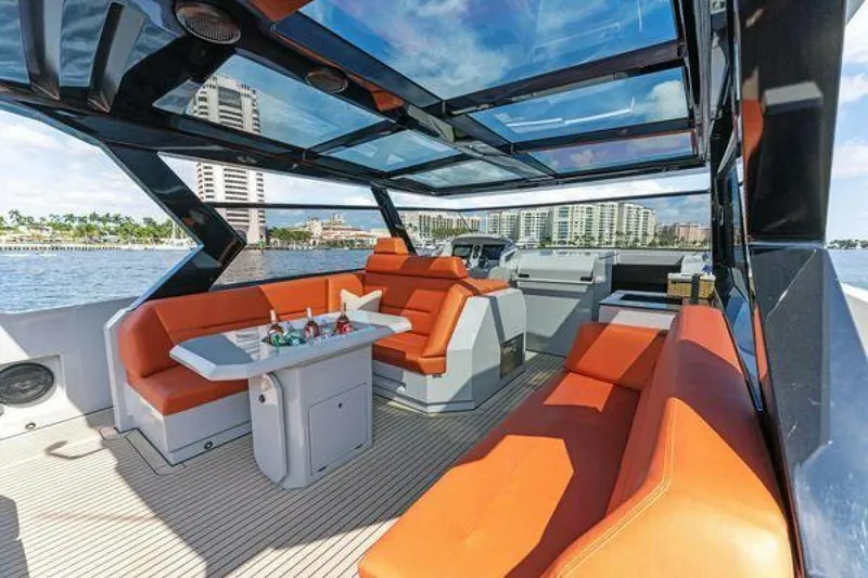 Slide: The Image of Luxurious 2021 Vanquish VQ58 yacht interior with orange seating and panoramic views. - 14