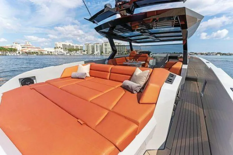 Slide: The Image of Luxurious 2021 Vanquish VQ58 yacht with spacious orange seating on open water. - 15