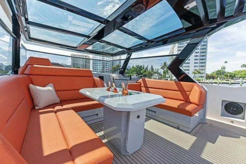 Slide: The Image of Luxurious 2021 Vanquish VQ58 yacht interior with orange seating and glass roof. - 19