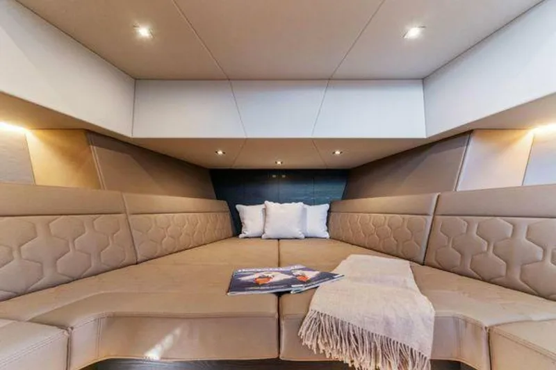 Slide: The Image of Luxurious interior of 2021 Vanquish VQ58 yacht with plush seating and ambient lighting. - 21