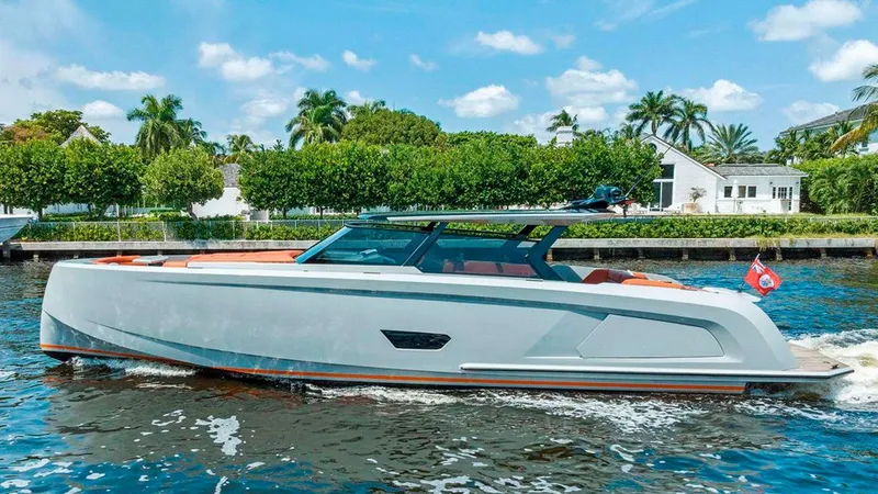 Slide: The Image of 2021 Vanquish VQ58 yacht cruising on a sunny day, surrounded by lush greenery. - 3