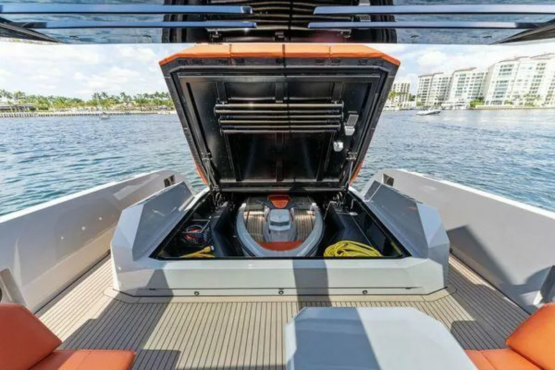 Slide: The Image of 2021 Vanquish VQ58 yacht with open engine compartment, docked near waterfront buildings. - 35
