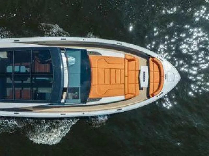 Slide: The Image of Aerial view of 2021 Vanquish VQ58 yacht with orange seating on water. - 5