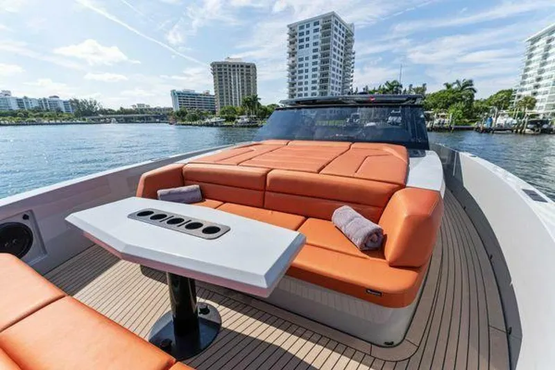 Slide: The Image of Luxurious 2021 Vanquish VQ58 yacht with orange seating, docked near waterfront buildings. - 8