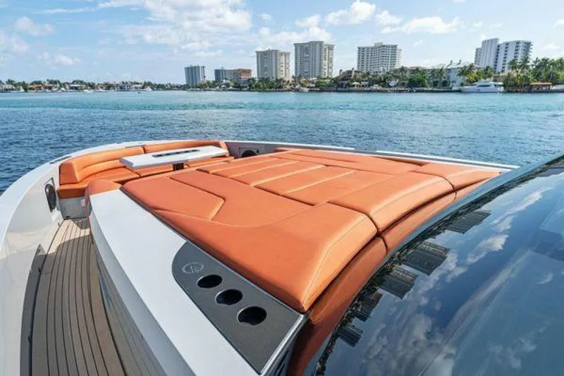 Slide: The Image of Vanquish VQ58 yacht with orange sunbathing deck, city skyline in background, 2021 model. - 9
