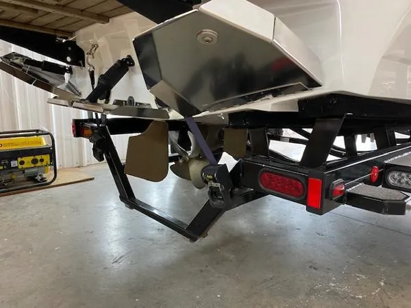 Slide: The Image of 2017 MasterCraft NXT22 boat trailer with metal frame and rear view in a garage. - 8