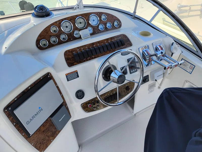 Slide: The Image of 2001 Bayliner 3488 Command Bridge Motoryacht helm with Garmin navigation and classic instrument panel. - 17