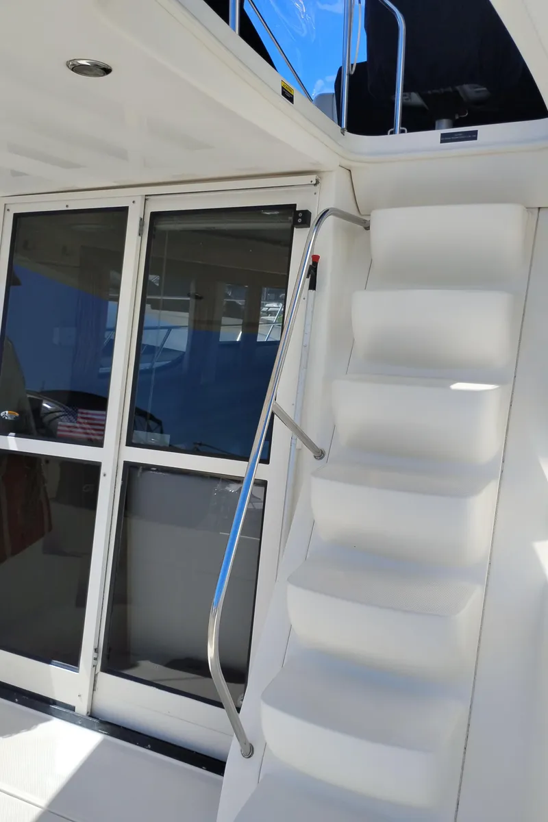 Slide: The Image of 2001 Bayliner 3488 Command Bridge Motoryacht with stairs and sliding glass doors. - 24