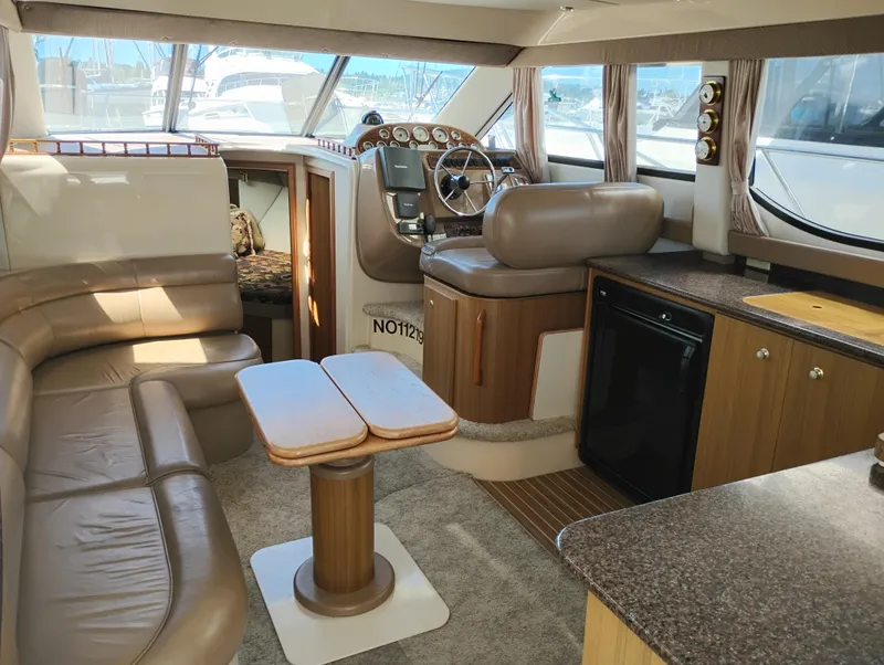 Slide: The Image of 2001 Bayliner 3488 Command Bridge Motoryacht interior with seating, helm, and kitchenette. - 33