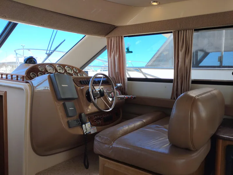 Slide: The Image of 2001 Bayliner 3488 Command Bridge Motoryacht interior helm with leather seating and control panel. - 35