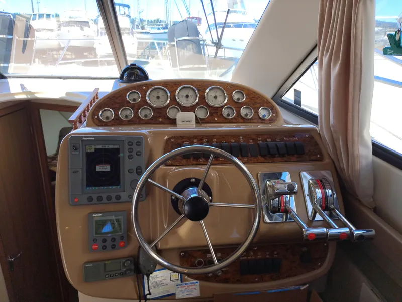 Slide: The Image of 2001 Bayliner 3488 Command Bridge Motoryacht helm with gauges, controls, and navigation equipment. - 36