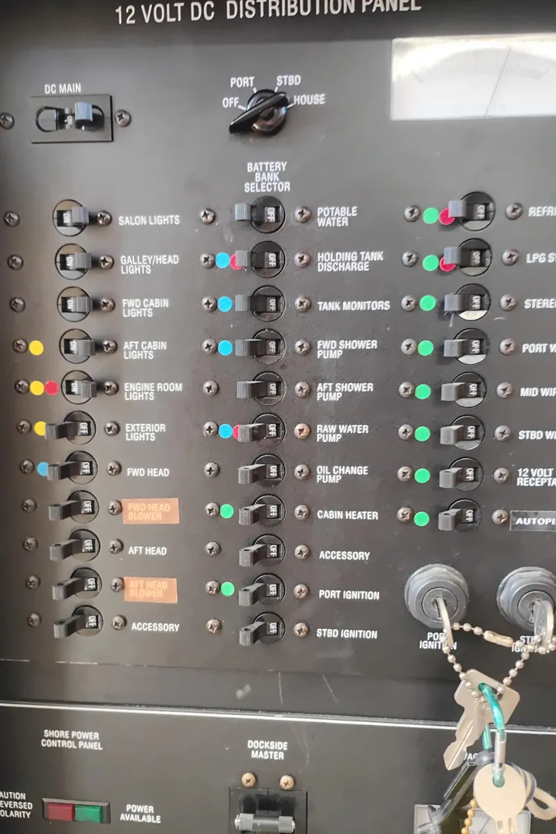 Slide: The Image of 12V DC distribution panel on 2001 Bayliner 3488 Command Bridge Motoryacht with labeled switches and keys. - 38