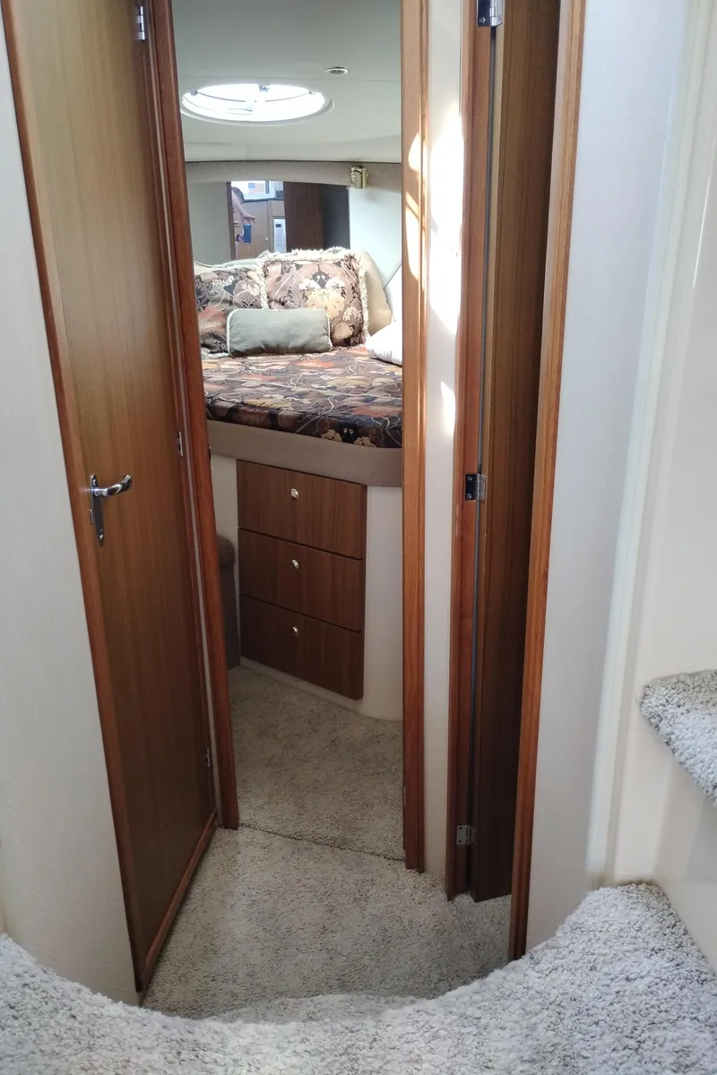 Slide: The Image of 2001 Bayliner 3488 Command Bridge Motoryacht interior with cozy bedroom and wooden cabinetry. - 42