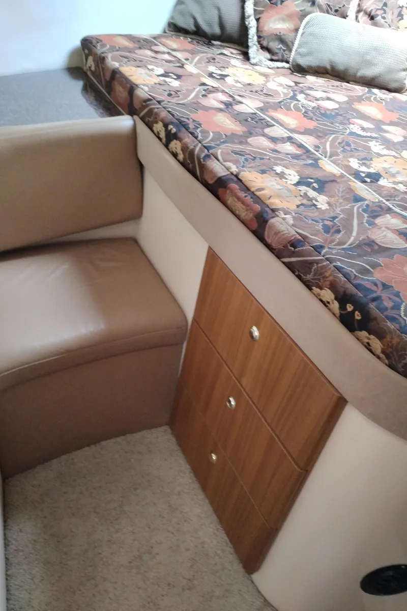 Slide: The Image of Interior of 2001 Bayliner 3488 Command Bridge Motoryacht with floral bedding and wooden drawers. - 45