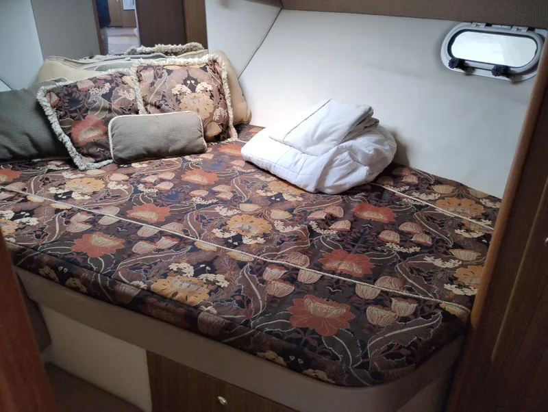 Slide: The Image of Cozy cabin bed with floral bedding in 2001 Bayliner 3488 Command Bridge Motoryacht. - 46