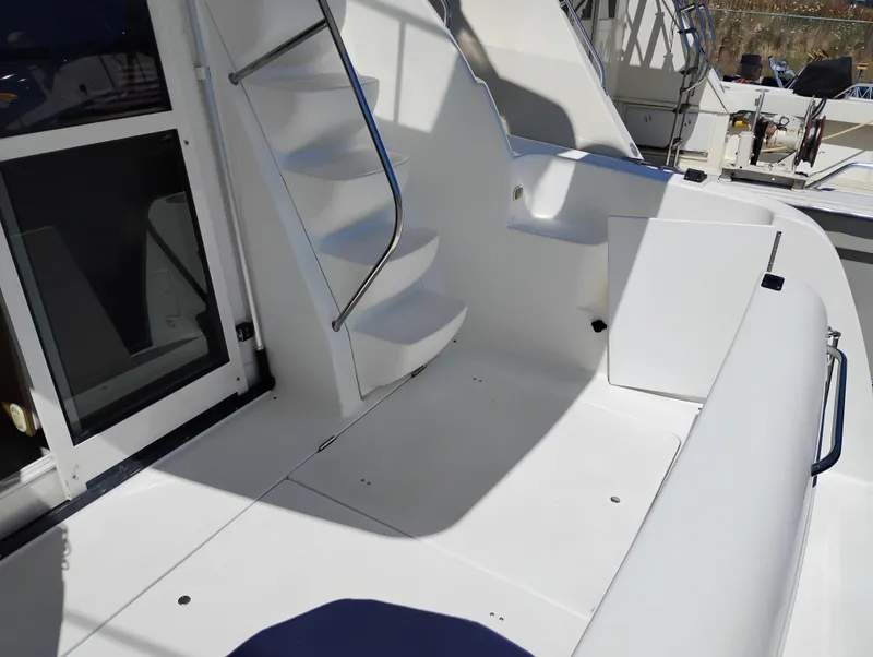 Slide: The Image of 2001 Bayliner 3488 Command Bridge Motoryacht deck with stairs and seating area. - 5