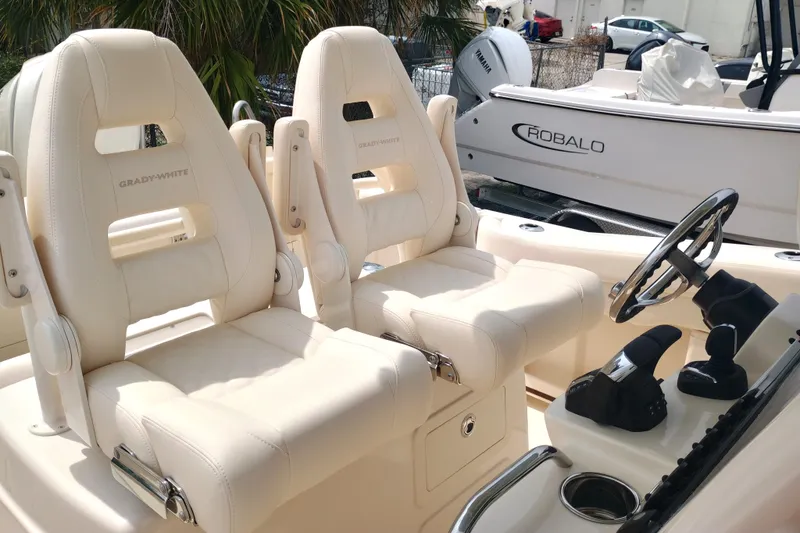 Slide: The Image of 2025 Grady-White Canyon 271 boat interior with plush seating and steering console. - 13