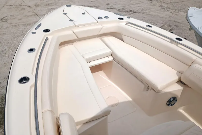 Slide: The Image of 2025 Grady-White Canyon 271 boat interior with cushioned seating and sleek design. - 22