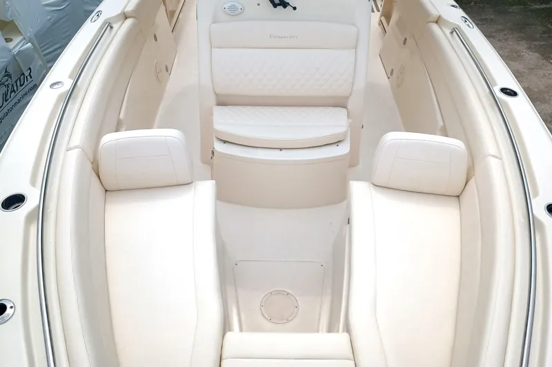 Slide: The Image of 2025 Grady-White Canyon 271 boat interior with white cushioned seating. - 24
