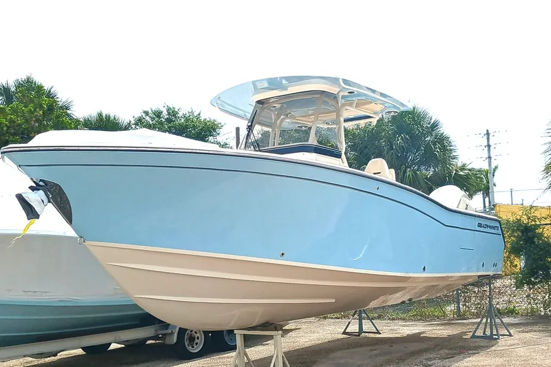 Slide: The Image of 2025 Grady-White Canyon 271 boat displayed outdoors on stands. - 3