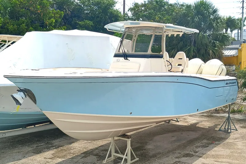 Slide: The Image of 2025 Grady-White Canyon 271 boat in light blue, docked outdoors. - 5