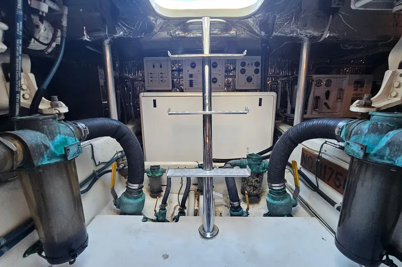 Slide: The Image of Engine room of a 2005 San Juan 48 yacht, featuring pipes and control panels. - 88