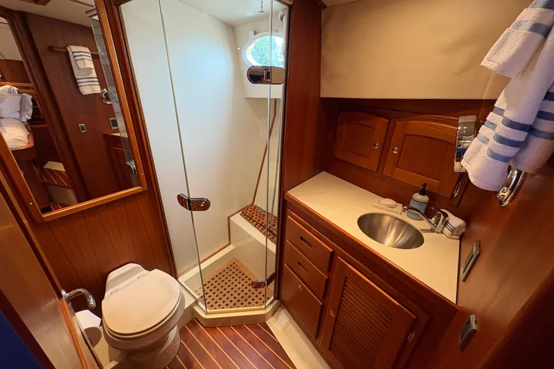 Slide: The Image of Luxurious 2005 San Juan SJ 48 Flybridge yacht bathroom with wood accents and modern amenities. - 71