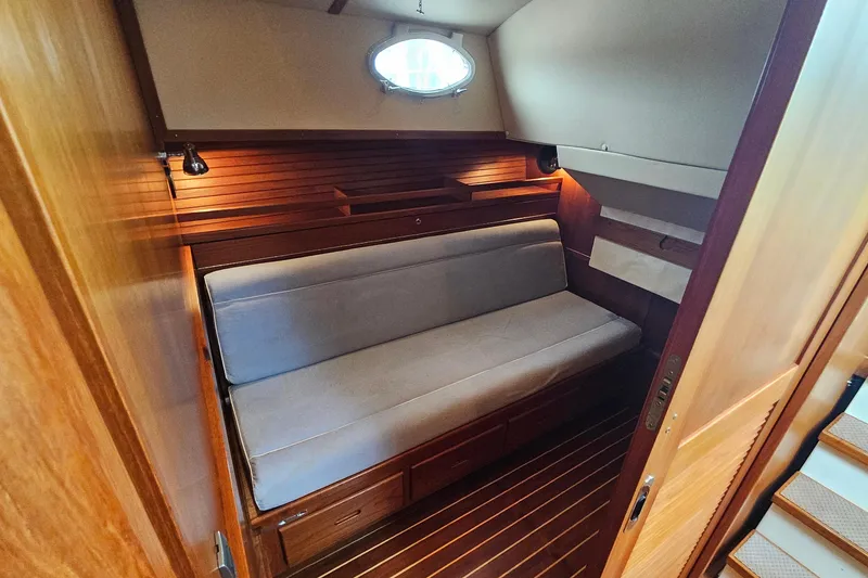 Slide: The Image of Luxurious cabin interior of 2005 San Juan 48 yacht with wooden finishes and cozy seating. - 65
