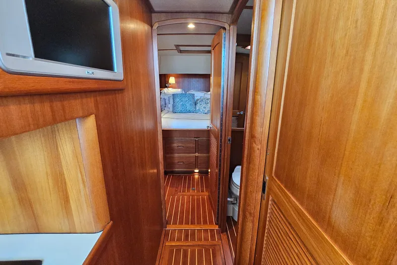 Slide: The Image of Luxurious wooden interior of 2005 San Juan 48 yacht, featuring cozy bedroom and modern amenities. - 66