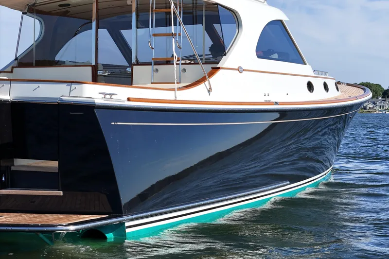 Slide: The Image of 2005 San Juan SJ 48 Flybridge yacht on water, showcasing sleek design and elegant craftsmanship. - 15