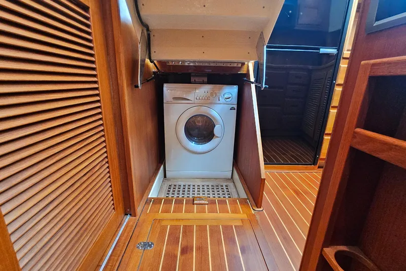 Slide: The Image of Laundry area inside 2005 San Juan 48 yacht with wooden interior. - 76