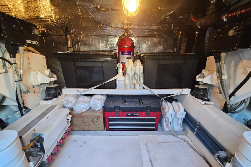 Slide: The Image of Engine room of 2005 San Juan 48 yacht with tools and storage containers. - 84