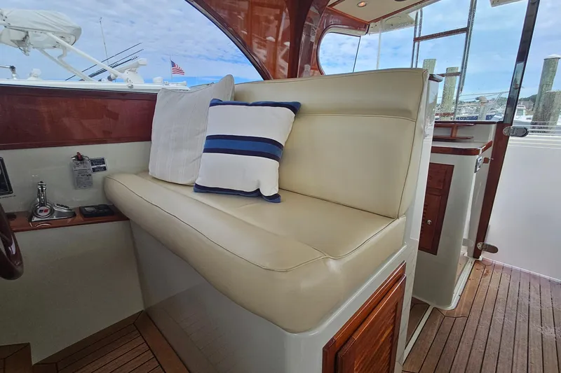 Slide: The Image of Luxurious seating area on a 2005 San Juan 48 yacht with plush cushions and wooden accents. - 51