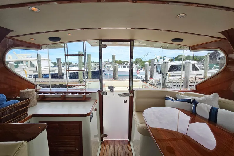 Slide: The Image of Interior view of 2005 San Juan 48 yacht with elegant wood finish and marina backdrop. - 44