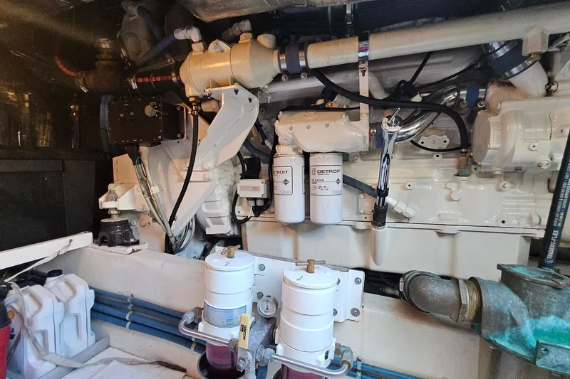 Slide: The Image of Engine room of a 2005 San Juan 48 yacht, featuring Detroit filters and mechanical components. - 78