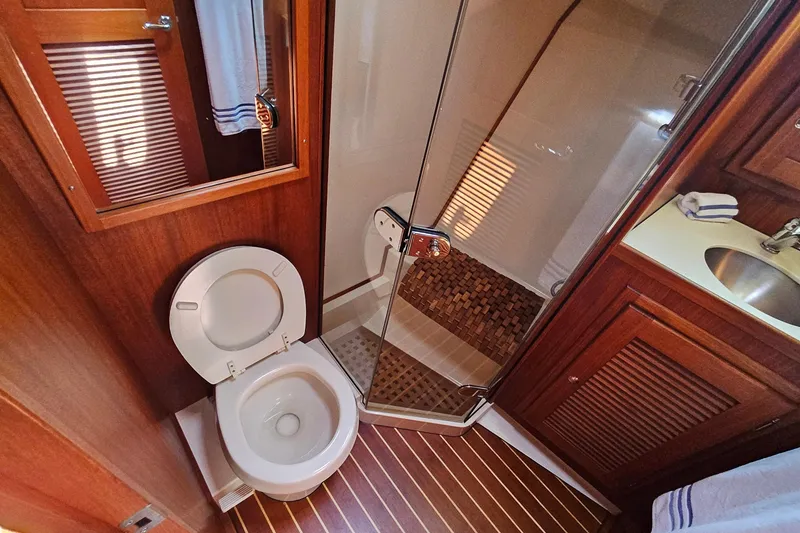 Slide: The Image of Luxurious 2005 San Juan 48 yacht bathroom with wooden accents and glass shower. - 68