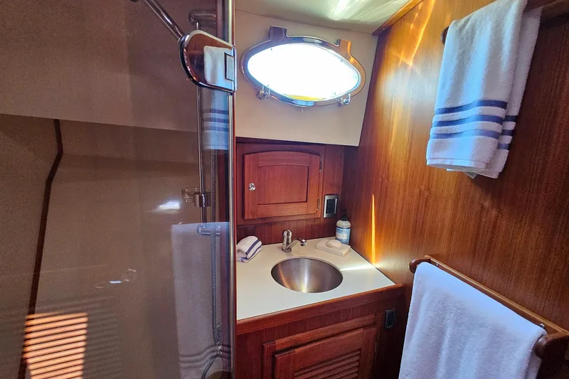 Slide: The Image of Luxurious bathroom interior of 2005 San Juan 48 yacht with wooden cabinetry and stainless steel sink. - 67