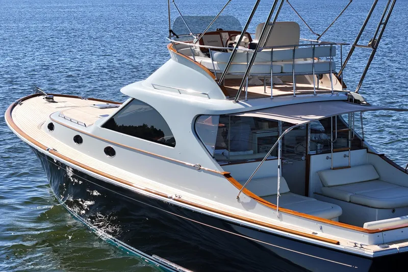 Slide: The Image of 2005 San Juan SJ 48 Flybridge yacht on calm blue waters. - 24