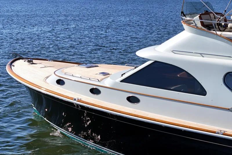 Slide: The Image of 2005 San Juan SJ 48 Flybridge yacht cruising on calm blue waters. - 22