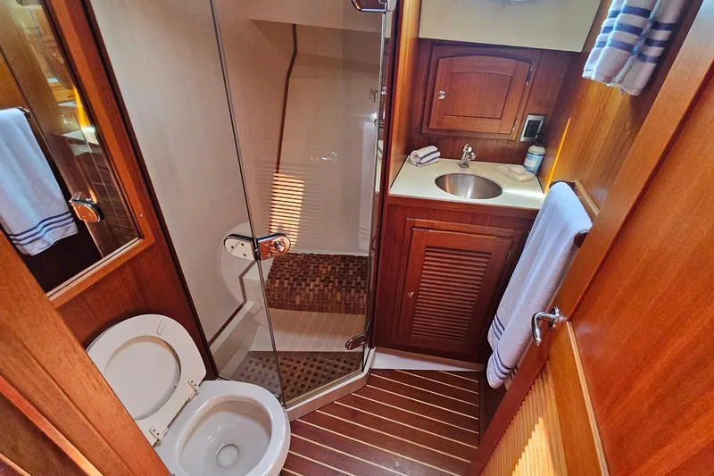 Slide: The Image of Luxurious 2005 San Juan 48 yacht bathroom with wooden cabinetry and modern fixtures. - 69