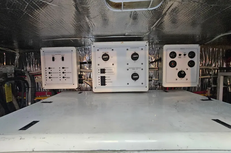 Slide: The Image of Electrical control panels in a 2005 San Juan 48 boat engine room. - 79
