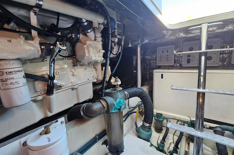 Slide: The Image of Engine room of a 2005 San Juan 48 yacht, featuring Detroit oil filter and mechanical components. - 83