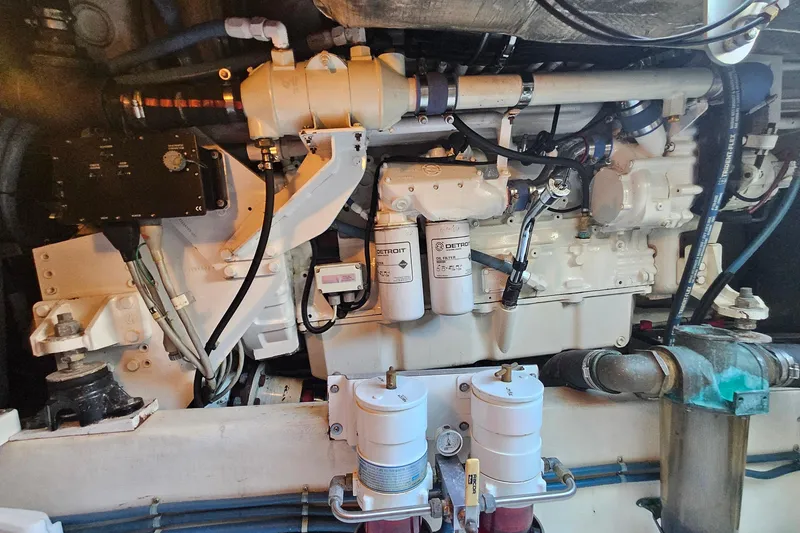 Slide: The Image of Engine room of a 2005 San Juan 48 yacht, showcasing mechanical components and filters. - 82