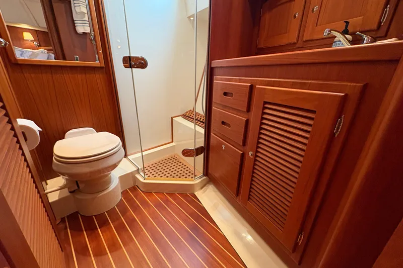 Slide: The Image of Luxurious 2005 San Juan SJ 48 Flybridge yacht bathroom with wooden cabinetry and glass shower. - 70