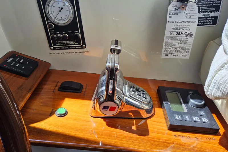 Slide: The Image of Control panel of a 2005 San Juan 48 yacht with throttle and gauges. - 56